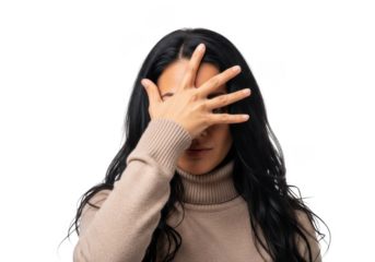 Woman covering face with hand, hiding, shame, disappointment, sadness, mystery, dark hair, beige turtleneck isolated on transparent background