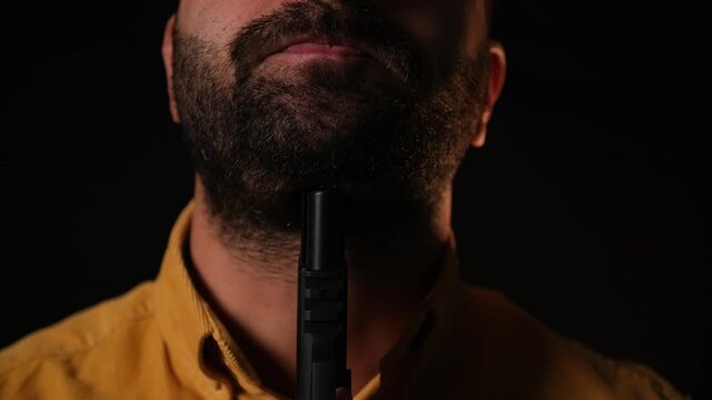Man Holding a Handgun to His Throat &mdash; Staged Conceptual Shot (Sensitive Content)