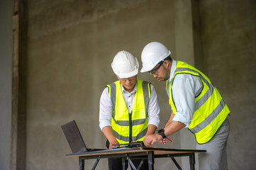 Male engineer and architect are checking the integrity of the building structure inside the building