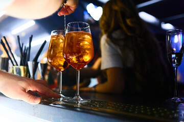 Close-up of Aperol Spritz drinks with ice cubes