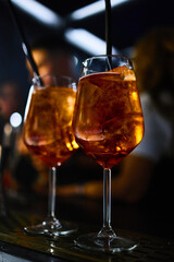 Close-up of Aperol Spritz drinks with ice cubes