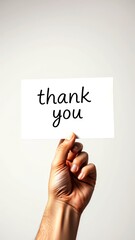 Hand holds thank you card against neutral background conveying gratitude in simple yet impactful manner