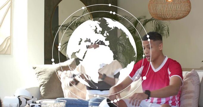 Friends reaching for VR controllers and sharing popcorn bowl before placing headsets for gaming