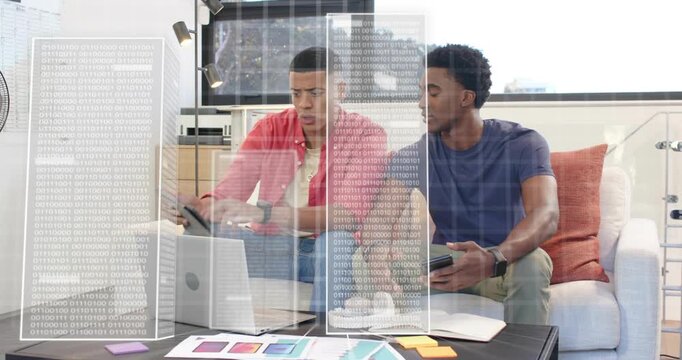 Colleagues coding using laptop and phone input, showing tablet screens and organizing color charts