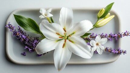 Naklejka premium Elegant arrangement of white lilies accompanied by delicate purple lavender and small white flowers on a minimalist plate, showcasing nature's beauty and tranquility.