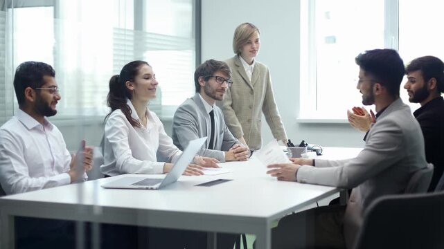 A group of people shaking hands in a conference room