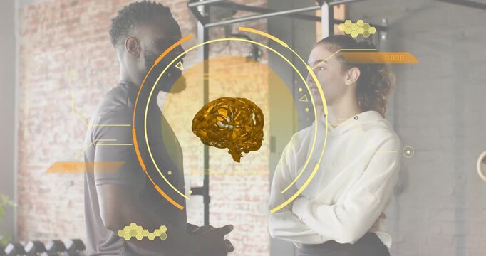 Gym trainer activating rotating brain graphic while sharing mental boost before shaking hands