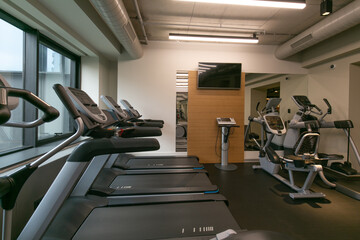 Workout area in gym with treadmills and cycling machines