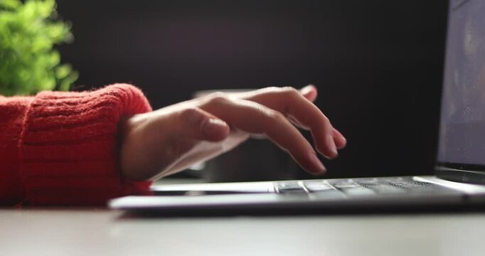 Hands and fingers of woman pressing buttons on keyboard, typing on laptop and scrolling on computer on work office table, using modern technology, digital gadget for business. Close up cropped shot
