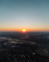 Aerial countryside with summer fields, small villages and sunrise sky scenery