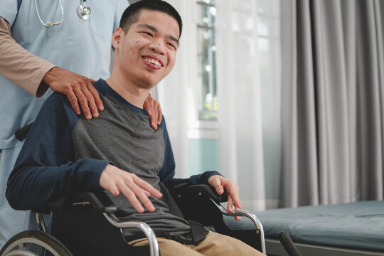 A young man with disability and a kind doctor encourage to patient in examination room, Activity in hospital , home, quarantine, Symptom monitoring and consultation by a specialist,Healthcare concept.