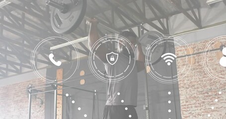 Man steadying barbell in gym activating package network for logistics technology via animated icons - Powered by Adobe
