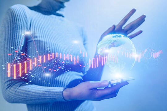 Person holding mobile device with financial graphs and Earth globe illustration.