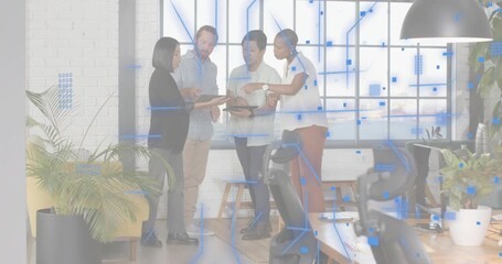 Male colleague gesturing toward peer tablet causing digital particles forming for business analysis - Powered by Adobe