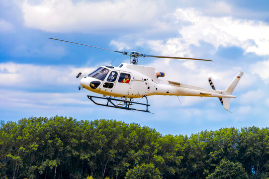 Bautzen, Germany, 2025 – Helicopter D-HAIB lifting off above trees and airfield. Aviation in action – dynamic takeoff of a single-engine helicopter with pilot in cockpit