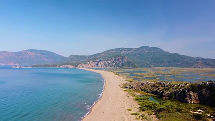 aerial perspective captures the beauty of İztuzu Beach in Dalyan, Turkey. Known as Turtle Beach due to its significance as a nesting site for endangered loggerhead sea turtles Caretta caretta, this pr
