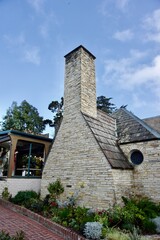 Fototapeta premium A close-up stone chimney and rustic slate roof in Carmel, California.