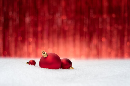 Christmas Background With Red Baubles On Snow And Festive Copy Space