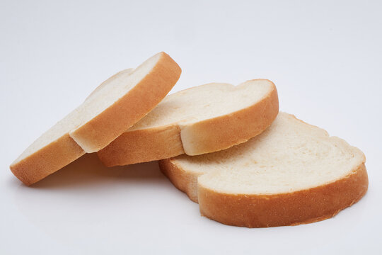 Three slices of Jamaican hard dough bread isolated on a white background.