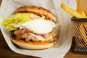 Burger with poached egg and fries