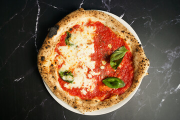 Half margherita and marinara pizza with basil and garlic