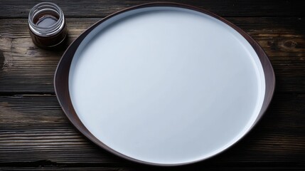 Empty round plate on dark wooden tableware