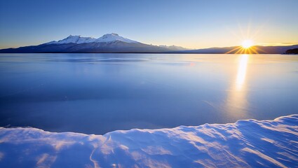 Winter lake reflecting snowy peaks