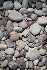 An abundant assortment of natural river stones, displaying a spectrum of neutral and earthy hues