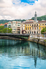 Colorful Vertical Travel Photo of Bilbao with Bridge, City Hall and River Reflection