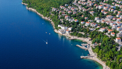 Fototapeta premium Aerial drone view of Crikvenica and Dramalj with turquoise Adriatic Sea, green-blue waters, beaches, and the island of Krk in the distance. Taken on 27.09.2025 in Dramalj, Croatia.
