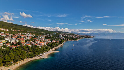 Fototapeta premium Aerial drone view of Crikvenica and Dramalj with turquoise Adriatic Sea, green-blue waters, beaches, and the island of Krk in the distance. Taken on 27.09.2025 in Dramalj, Croatia.