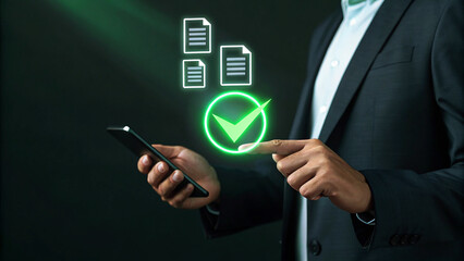 Businessman using smartphone to approve documents online with digital signature and green check mark on virtual screen