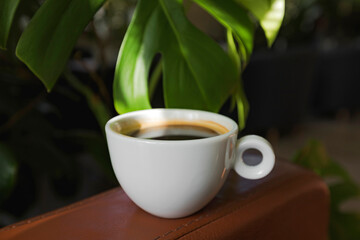 A cup of black coffee in a cafe with copy space