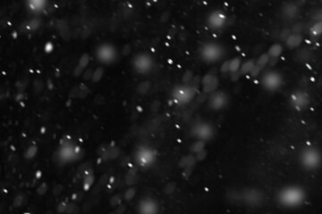 Fototapeta premium Snow overlay black background abstract texture, snowflakes falling in the sky. Layer to overlay and blend snowfall into your photo project. Snow on a black background. Use screen blending layer mode
