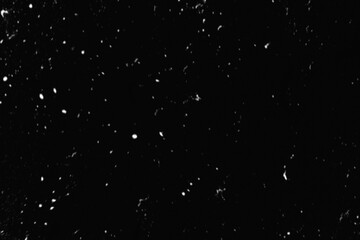 Falling Snow down On The Black Background. Blurry flecks snow overlay. White spots on black background. Abstract speckles overlay. Snowfall on black background - design element. For photo edit