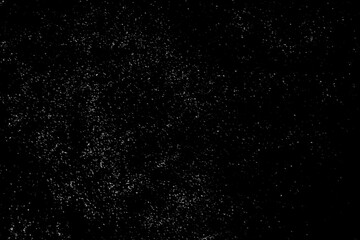 Light snowfall snow against black background. Works well as an overlay. Fine small snows. White snowflakes on black background, Blurred abstract defocused effect. Use with screen blending layer mode