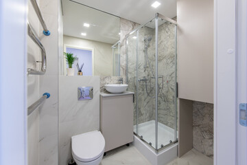 Bright Elegant Modern Luxury Home Bathroom Interior Design With White Sink. Marble Gray Walls, Mirror and Faucet. LED Lights. Shower Area, Heater, Tile Floor and Walls