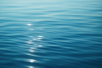 Glasslike blue water surface with sun glints gentle ripples and soothing gradients