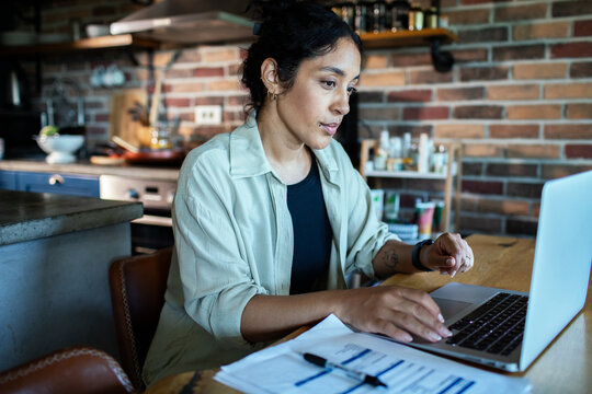Woman working on laptop at home