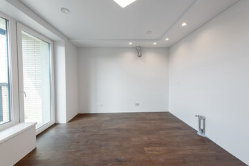 Empty Home Kitchen Interior. White Walls Room Corner and Windows. Interior Empty Room with White Walls and Wooden Floor.