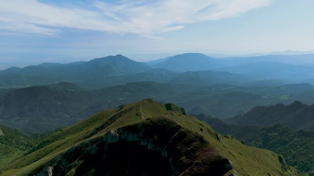 Spectacular early morning 360 degrees panoramic view in summer over Tiganesti Valley in Bucegi Mountains with blooming Carpathian rhododendrons on alpine slopes, Piatra Craiului, Bran Rucar corridor