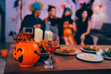 Joyful office Halloween party with coworkers in costumes, celebrating with drinks and laughter, fostering teamwork and festive spirit