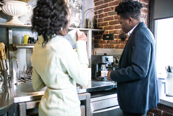 Professional Man In Suit And Woman In Light Jacket Sharing Coffee In Cozy Cafe