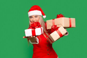 Santa woman offering Christmas gifts on a bright green background during the Christmas season