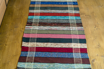 Striped rug-runner made of natural wool. Traditional colorful handmade rug.