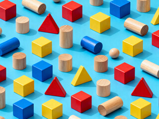 Obraz premium Colorful Wooden Building Blocks Scattered on Blue Background