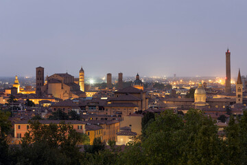 Aerial view of Bologna Cathedral and towers towering above of the roofs of Old Town in medieval city Bologna at night