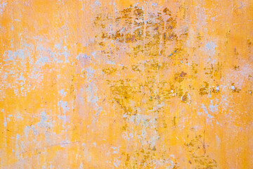 Background of old yellow painted wall. Old paint on a concrete wall