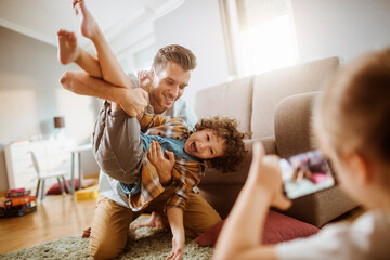 Father playing with son at home