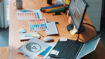 Close up of smart businessman hand choosing color palettes while designing logo graphic. Aerial view of professional interior designer design and select color theme by using color palettes. Symposium.